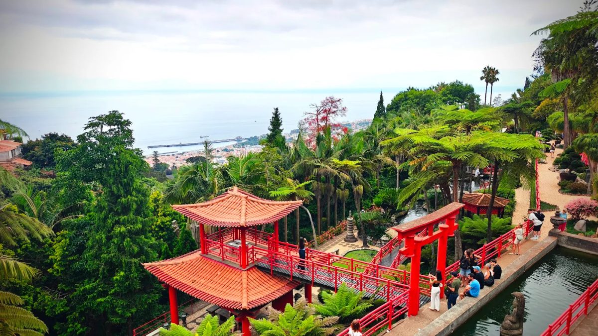 Red oriental bridge and pavilion with panoramic view over Funchal at Monte Palace Tropical Garden